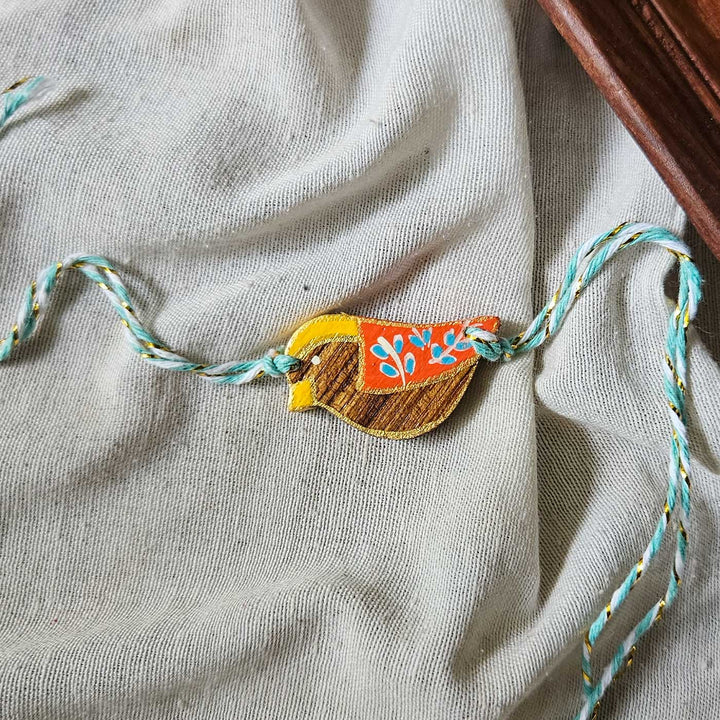 Handpainted Quirky Wooden Rakhi With Roli Chawal 4 New - Close-up with Extended Threads Visible