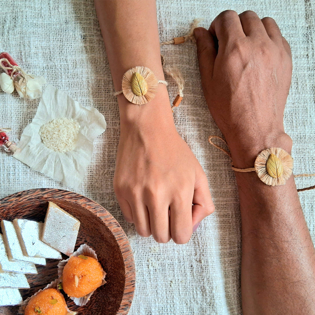 Handmade Papier Mache Yellow And Blue Leaf Rakhi With Roli Chawal Set Of 2 - Bracelets on Wrists with Sweets
