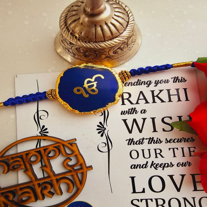 Handmade Ik Onkar Agate Rakhi With Roli Chawal For Brother - Front View of Blue Rakhi on Card