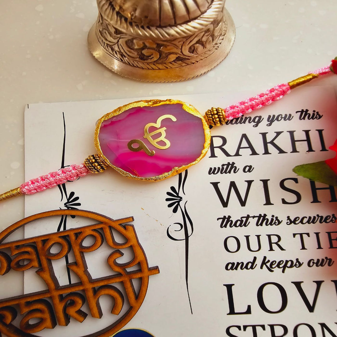 Handmade Ik Onkar Agate Rakhi With Roli Chawal For Brother - Front View of Pink Rakhi on Card