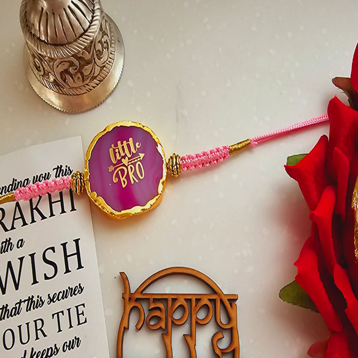 Handmade Pink Lil Bro Agate Rakhi With Roli Chawal For Brother - Close-Up of Rakhi Thread and Beads