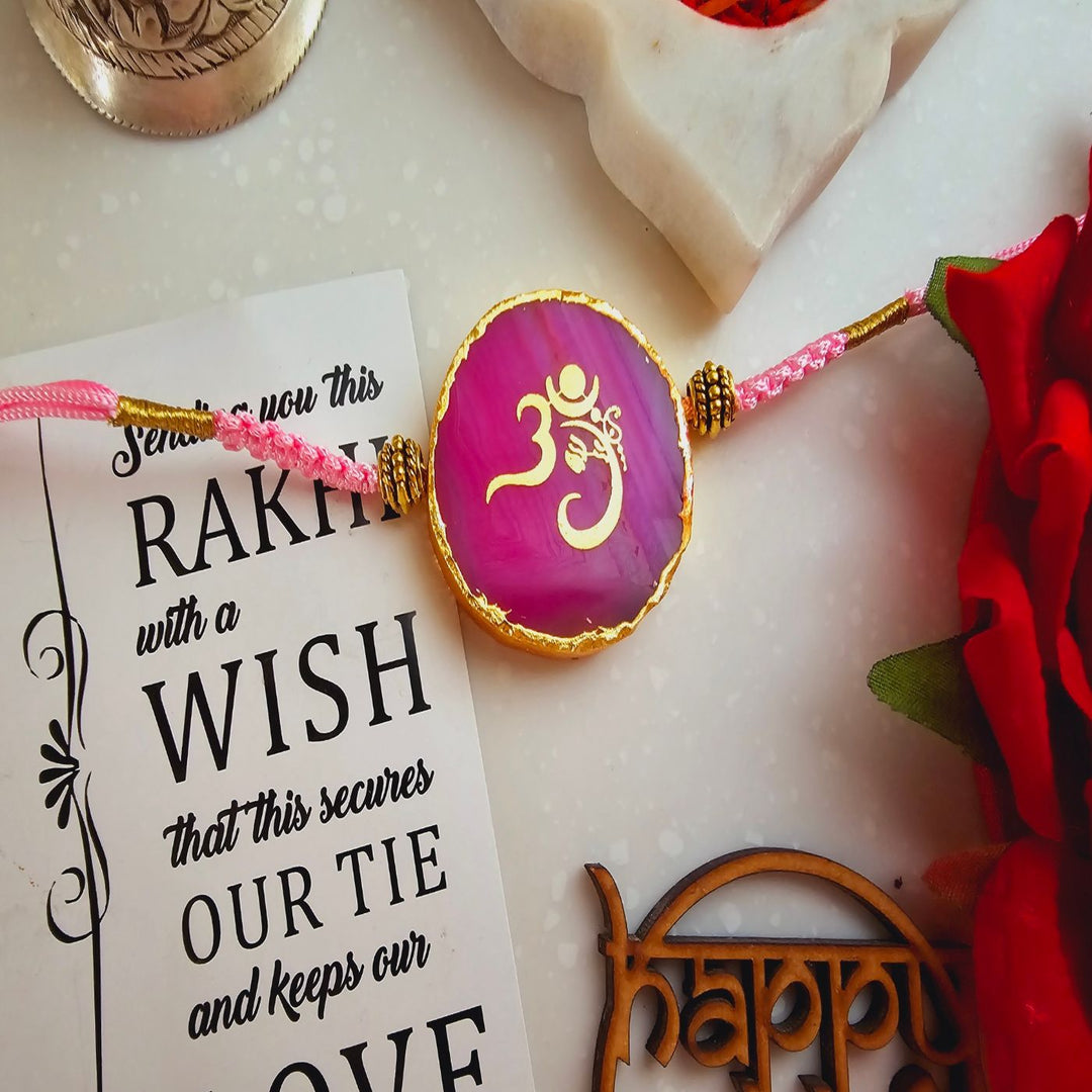 Handmade Om Agate Rakhi With Roli Chawal For Brother - Pink Rakhi Front Close-up