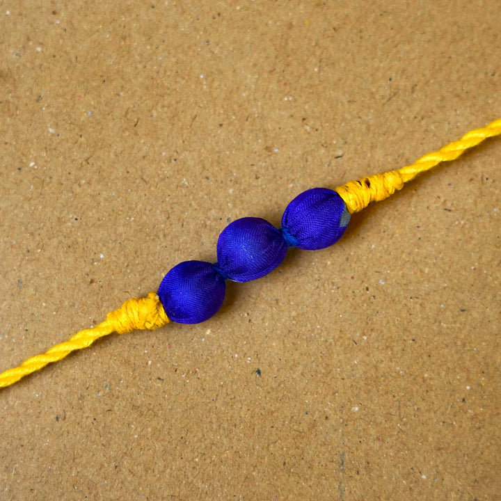Handmade Bright Yellow Upcycled Fabric  Rakhi  With Roli Chawal