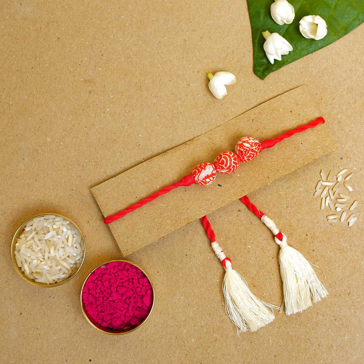 Handmade Red Upcycled Fabric Rakhi With Roli Chawal - Styled Rakhi with traditional items