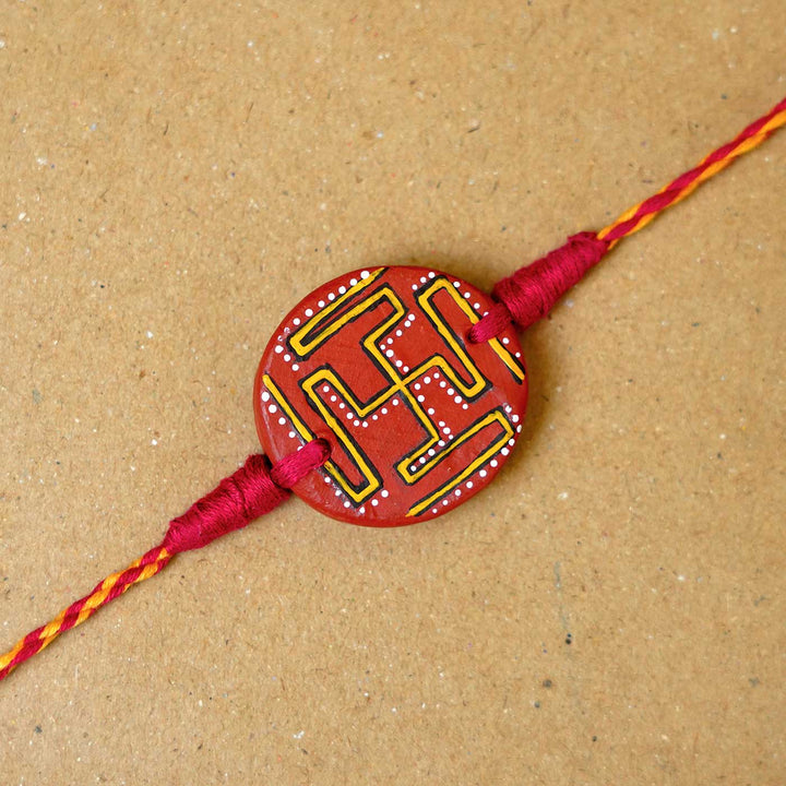 Hand-painted Swastik Terracotta Rakhi  With Roli Chawal
