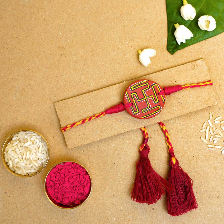 Hand-painted Swastik Terracotta Rakhi  With Roli Chawal