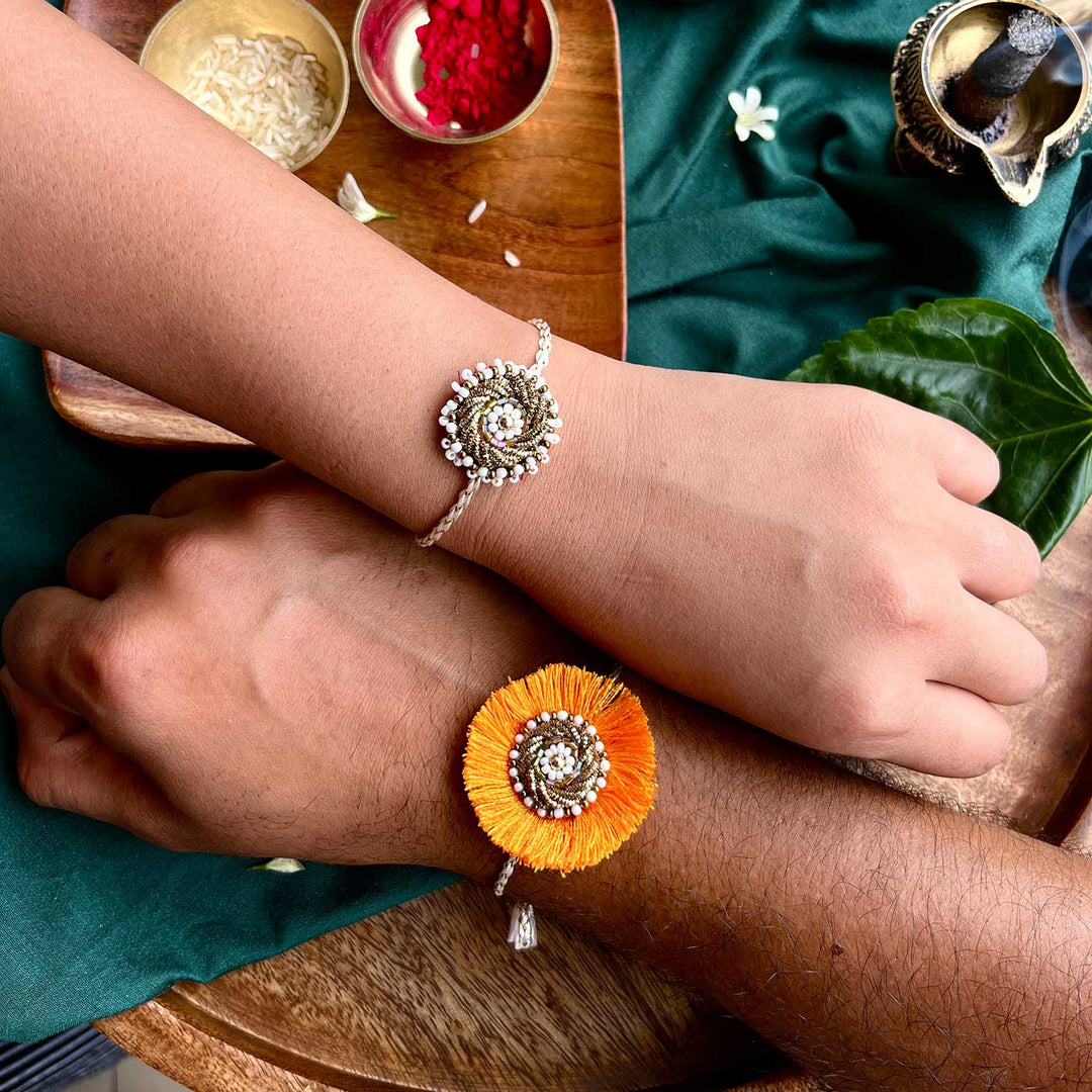 Handmade Zardozi Mustard And White Bead Work Bhaiya Bhabhi Rakhi With Wooden Box And Roli Chawal Set Of 2 - On Wrists Showing Size