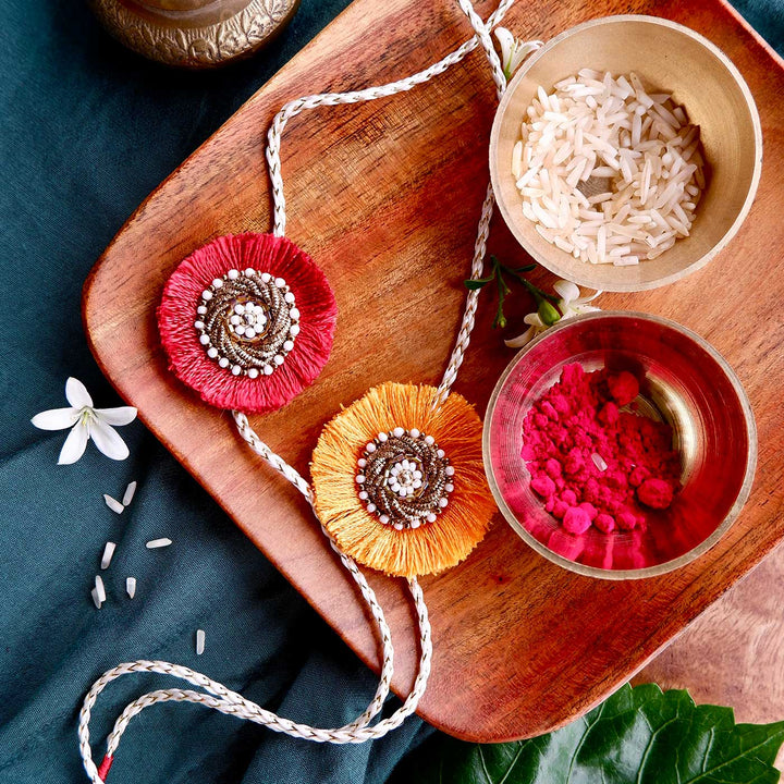 Handmade Zardozi Surajmukhi Rakhi With Wooden Box And Roli Chawal Set Of 2 - Laid flat with accessories