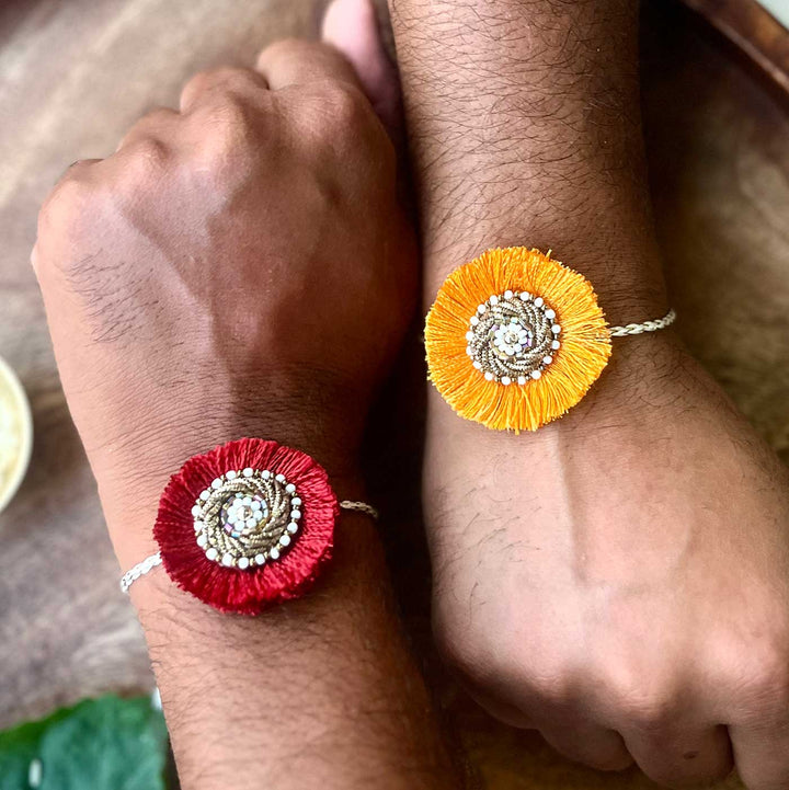Handmade Zardozi Surajmukhi Rakhi With Wooden Box And Roli Chawal Set Of 2 - On wrists showing pair