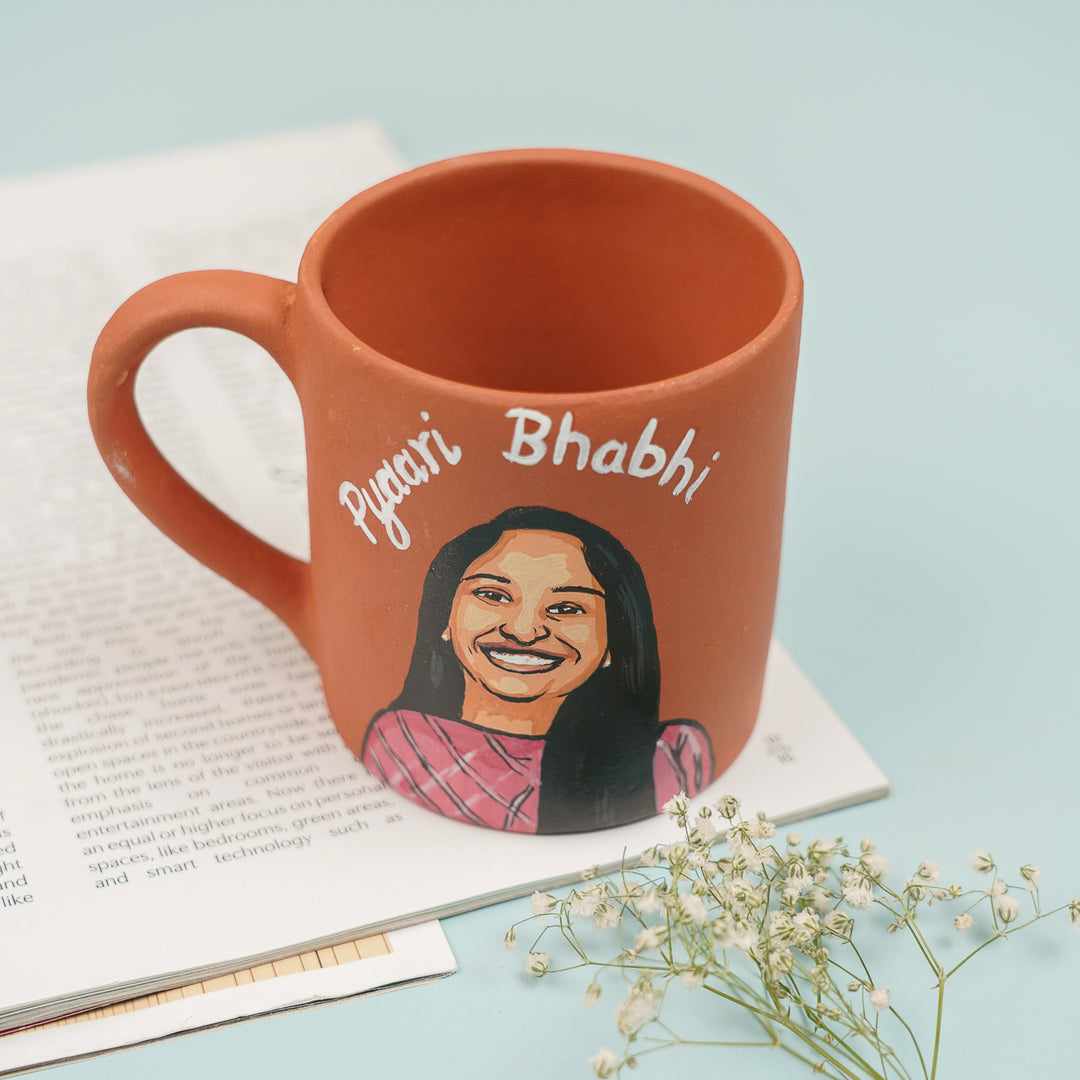 Photo Personalized Handmade Bhai And Bhabhi Theme Rakhi Hamper Includes 2 Mug 2 Rakhi - Top View of Mug on Book