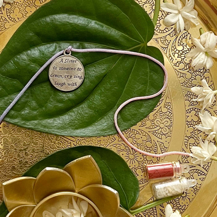 Engraved "A Sister Is Someone to Dream Cry Sing Laugh With" Quote Metal Charm Rakhi With Roli Chawal for Brother