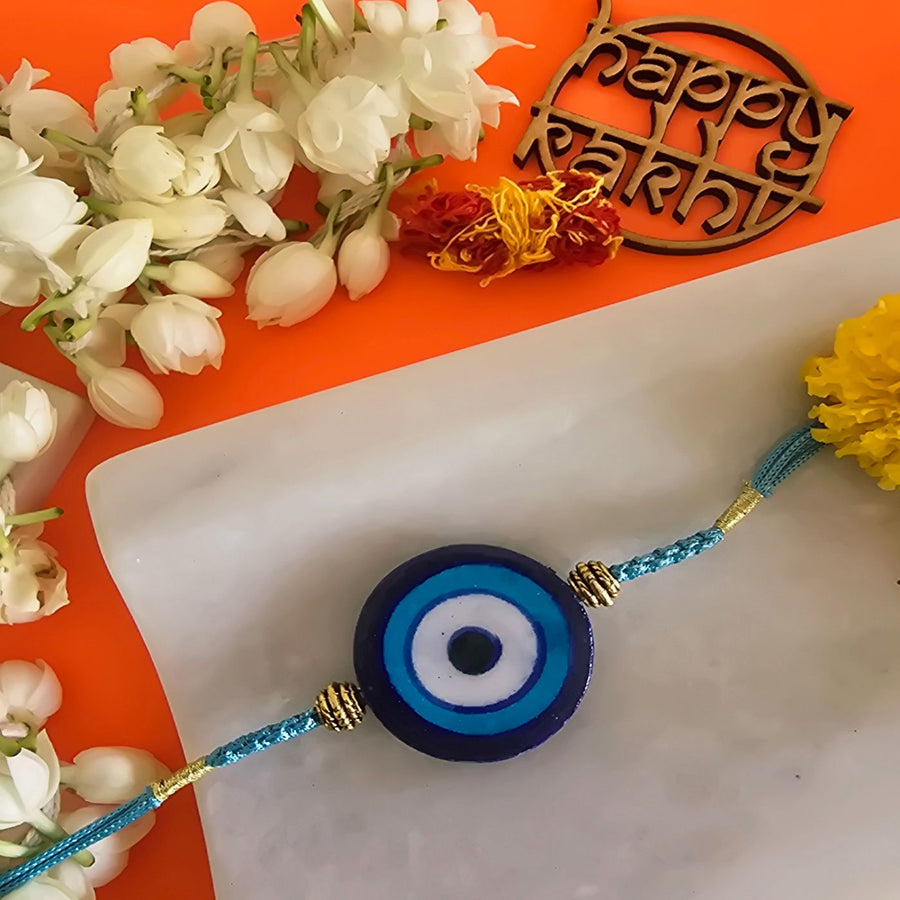Handmade Blue Pottery Evil Eye Ceramic Rakhi With Roli Chawal For Brother - Close-up of Rakhi Bracelet