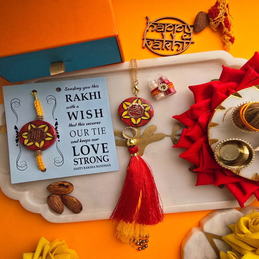 Handmade Red Gayatri Mantra Ceramic Bhaiya Bhabhi Rakhi With Roli Chawal - Flat Lay with Rakhi and Card