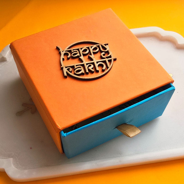 Handmade Laser Cut Red Bhai And Fab Bhabhi Ceramic Bhaiya Bhabhi Rakhi With Roli Chawal - Gift Box Top View