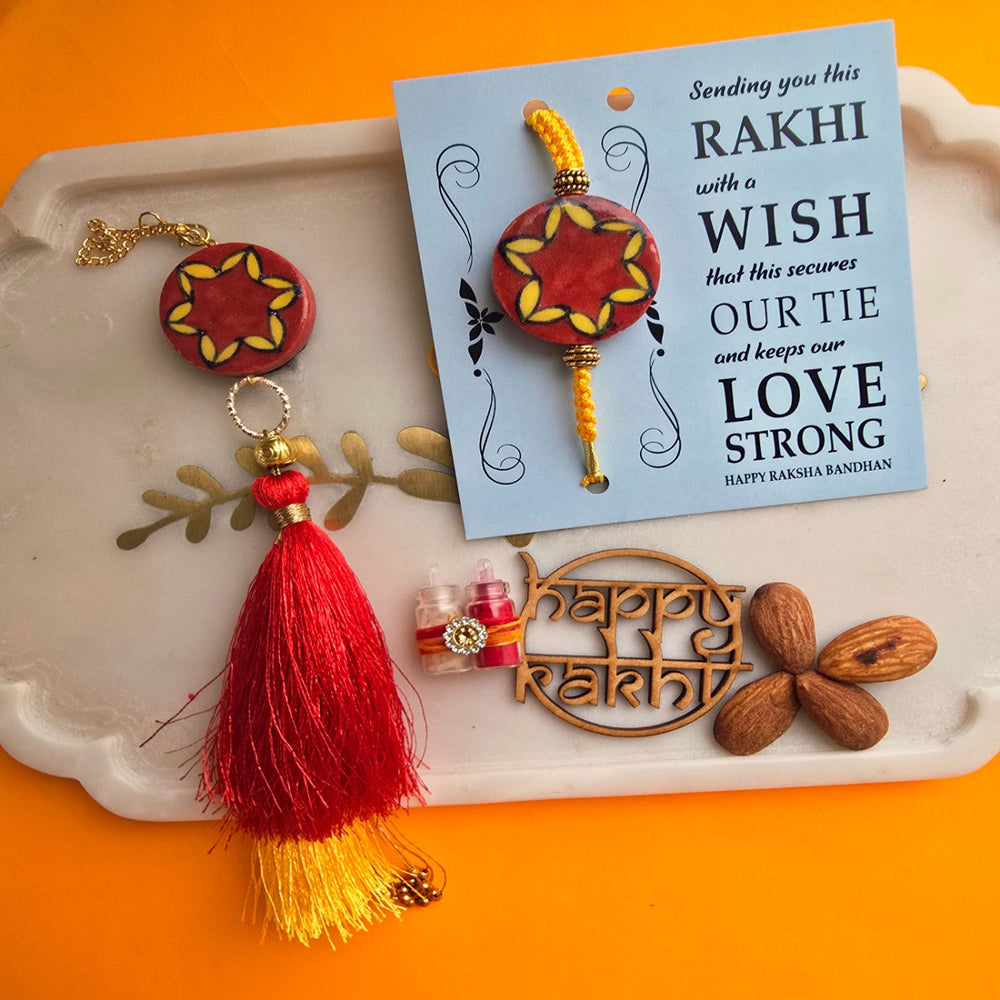 Handmade Red Florwer Design Ceramic Bhaiya Bhabhi Rakhi With Roli Chawal - Flat Lay with Accessories and Note