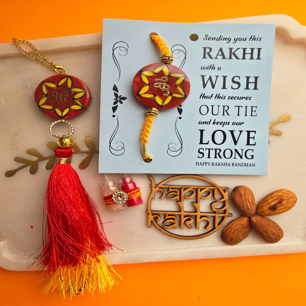 Handmade Laser Cut Red Ik Onkar Ceramic Bhaiya Bhabhi Rakhi With Roli Chawal - Close-up of Rakhi and Card