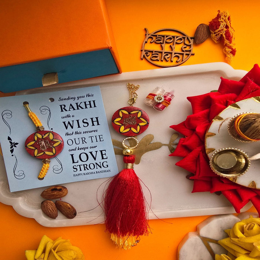 Handmade Laser Cut Red Jai Shree Krishna Ceramic Bhaiya Bhabhi Rakhi With Roli Chawal - Gift Set Display
