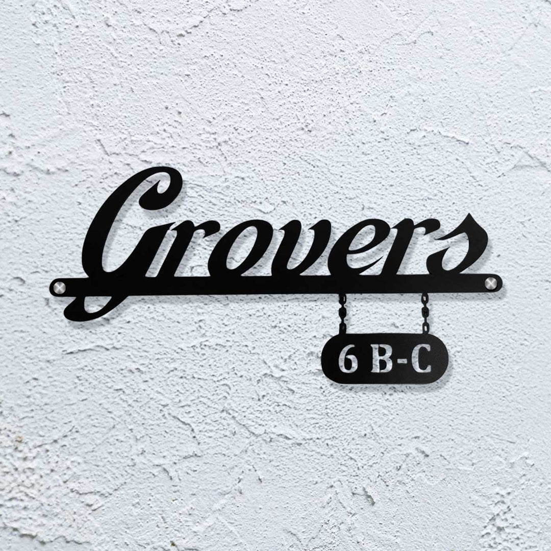Personalized Waterproof Sleek Black Metal Name Plate - Mounted on White Textured Wall