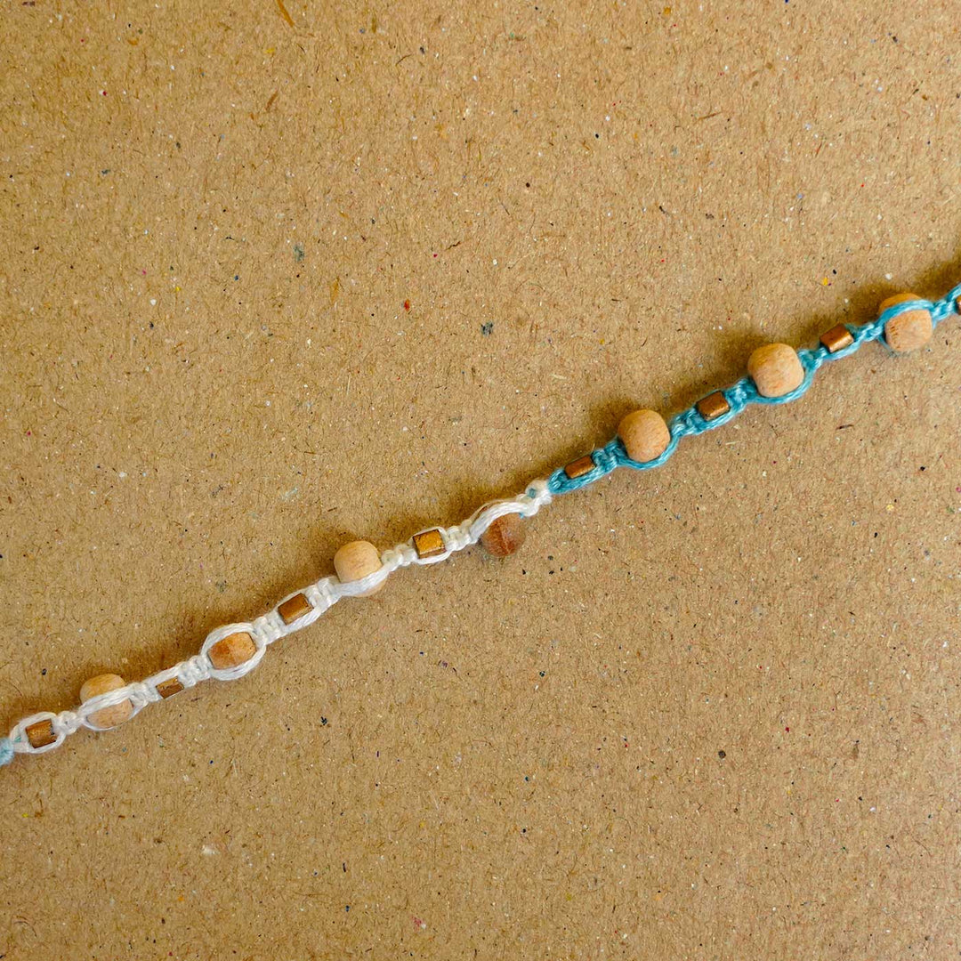 Reusable Beaded Blue Wooden Bead Rakhi With Roli Chawal - Close-up of bracelet beads