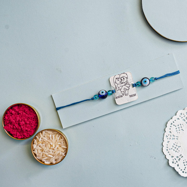 Personalized Handmade 3D Line Art Bro And Sis Evil Eye Beads Acrylic Rakhi With Roli Chawal - Mounted on Card with Accessories (4)