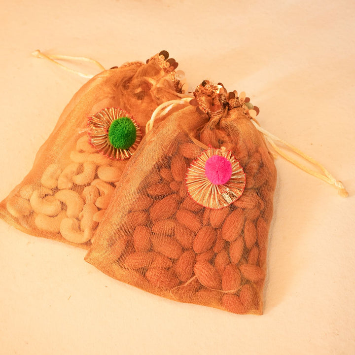 Anar Aura Diwali Gift Hamper | Includes 2 Dry Fruit Potlis, 2 Hangings, 1 Candle, 1 Ferrero Rocher Box, 2 Pomegranate Platters, 1 Diwali Card, 1 Gift Box