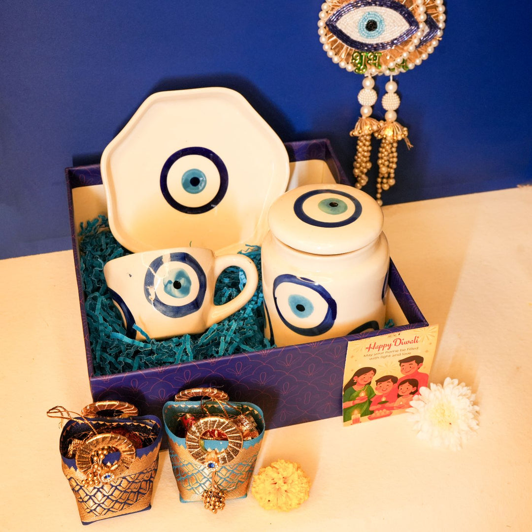 Nazar Suraksha Diwali Gift Hamper | Includes 1 Plate, 1 Mug, 1 Storage Container, 2 Hangings, 2 Dry Fruit Potlis, 1 Diwali Card, 1 Gift Box