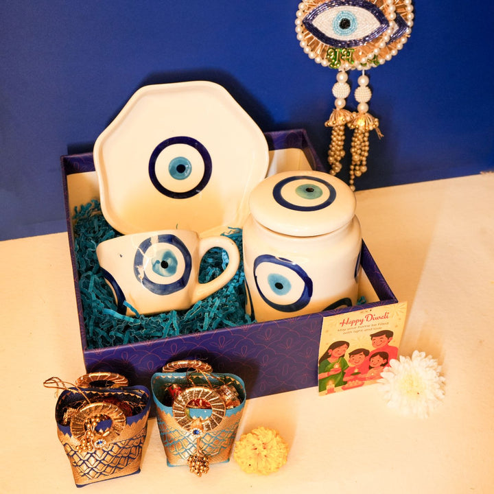 Nazar Suraksha Diwali Gift Hamper | Includes 1 Plate, 1 Mug, 1 Storage Container, 2 Hangings, 2 Dry Fruit Potlis, 1 Diwali Card, 1 Gift Box