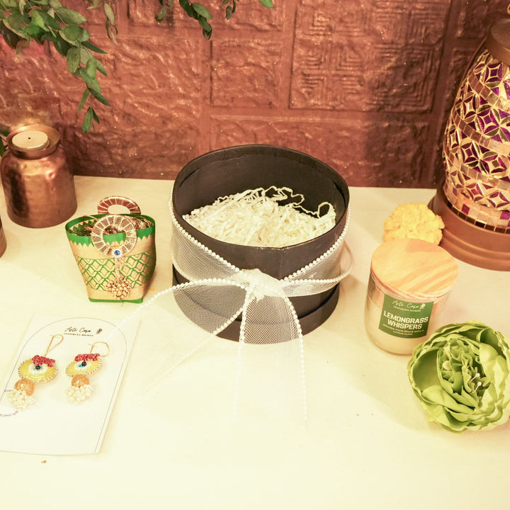 Aura Diwali Gift Hamper | Includes 2 Hangings, 1 Candle, 1 Dry Fruit Potli, 1 Decor Flower, 1 Diwali Card, 1 Round Gift Box