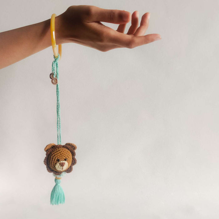 Handmade Crochet Lion Cub Kids Rakhi With Roli Chawal - Hand Holding Product with Tassel