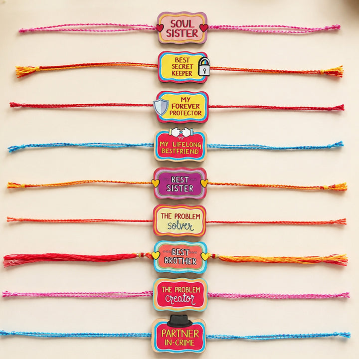 Glossy Printed Wooden Assorted Rakhi Combo With Kumkum Rice | Set of 9