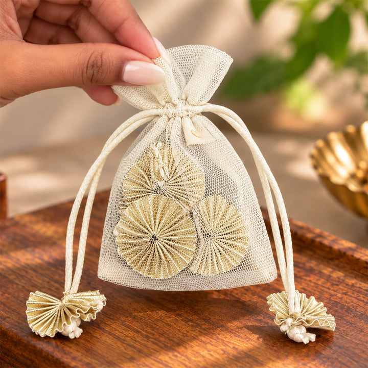 Hand-embellished Off-White Floral Net Potli With Gotapatti Flowers For Festive Gifting