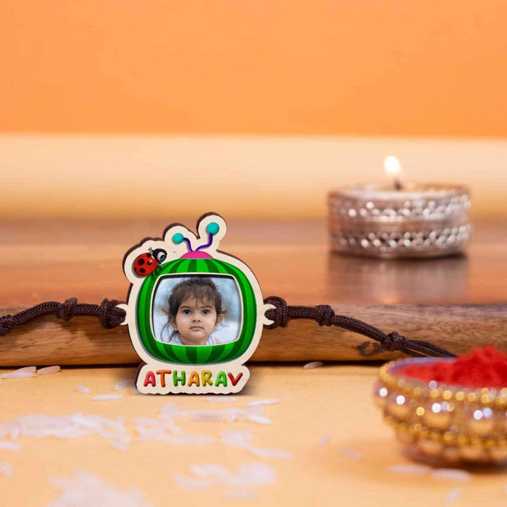 Photo Personalized Handmade Cocomelon Wooden Kids Rakhi With Roli Chawal - Front View with Festival Decoration