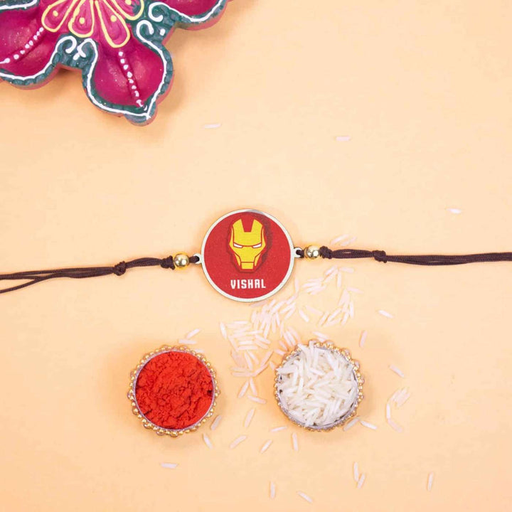 Personalized Handmade Iron Man Wooden Kids Rakhi With Roli Chawal - Flat Lay with Rakhi and Puja Items