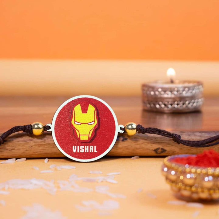 Personalized Handmade Iron Man Wooden Kids Rakhi With Roli Chawal - Rakhi on Wooden Surface with Decor