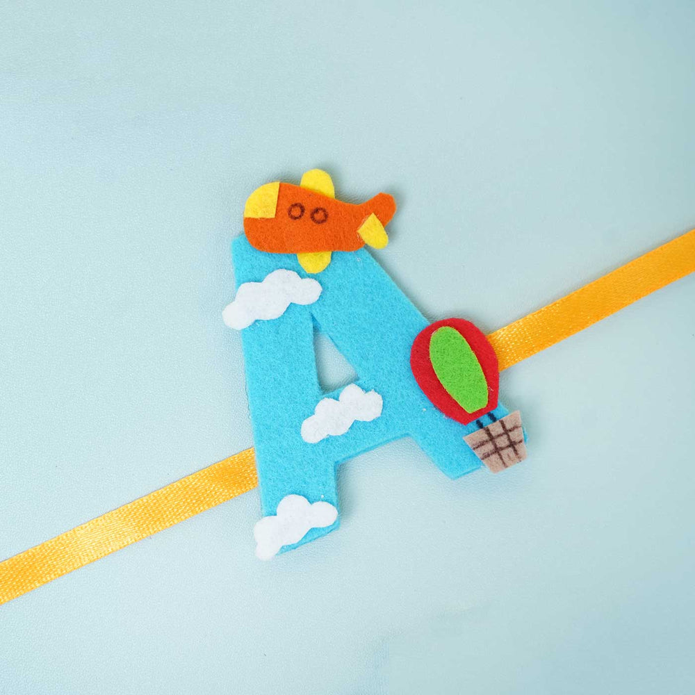 Personalised Handmade Hot Air Ballon Felt Rakhi With Chocolates Roli Chawal - Front View of Letter Ribbon