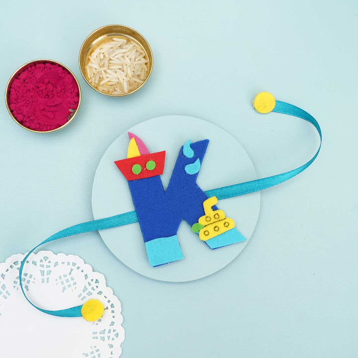 Personalised Handmade Boat Felt Rakhi With Chocolates Roli Chawal - Blue K Rakhi with Holi Items