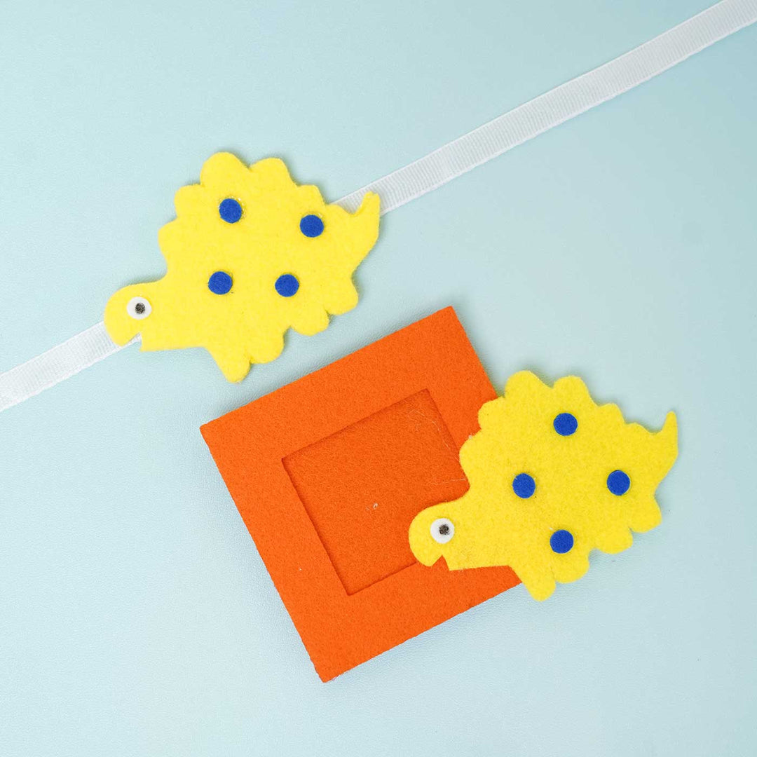 Handmade Blue Dinosaur Felt Rakhi Photoframe Magnet With Chocolates Roli Chawal - Single Rakhi on White Band