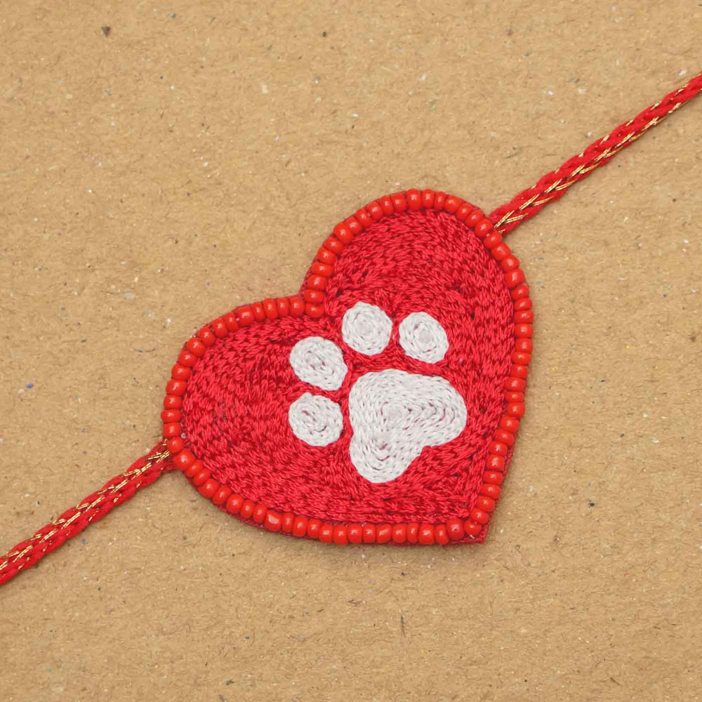 Handmade Beaded Paw Heart Rakhi With Roli Chawal - Close-up of heart with paw print