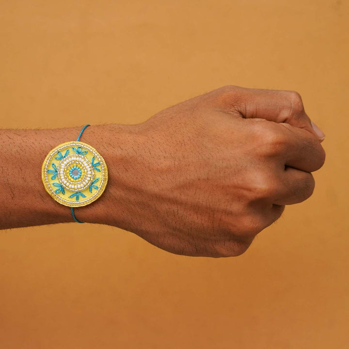 Handmade Beaded Round Rakhi With Roli Chawal - Wrist-mounted bracelet display