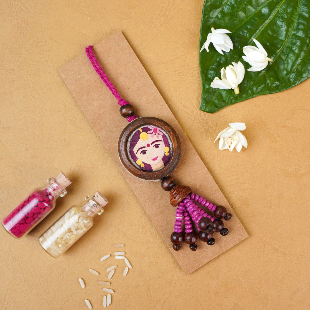 Handmade Eco Friendly Shakti Pressed Flower Lumba Rakhi For Bhabhi With Roli Chawal - Rakhi Placed on Cardboard with Decorative Items