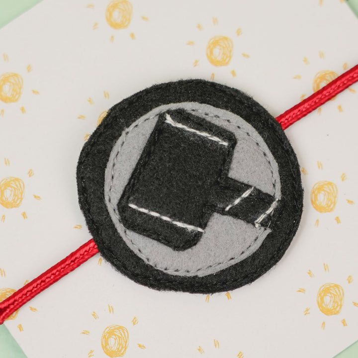 Handmade Thor Hammer Theme Felt Kids Rakhi For Brother - Close-up of Bracelet Emblem