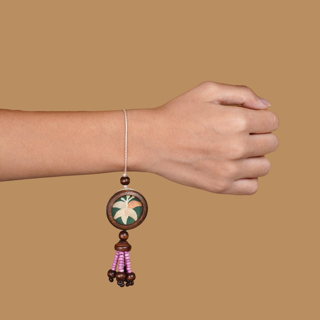 Handmade Eco Friendly Lily Pressed Flower Lumba Rakhi For Bhabhi With Roli Chawal - Worn on wrist example