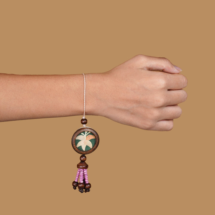Handmade Eco Friendly Lily Pressed Flower Lumba Rakhi For Bhabhi With Roli Chawal - Worn on wrist example