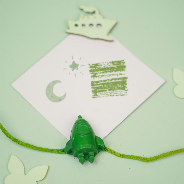 Customized Handmade Vehicles Theme Wax Rakhi For Kids - Styled Flat Lay with Rocket