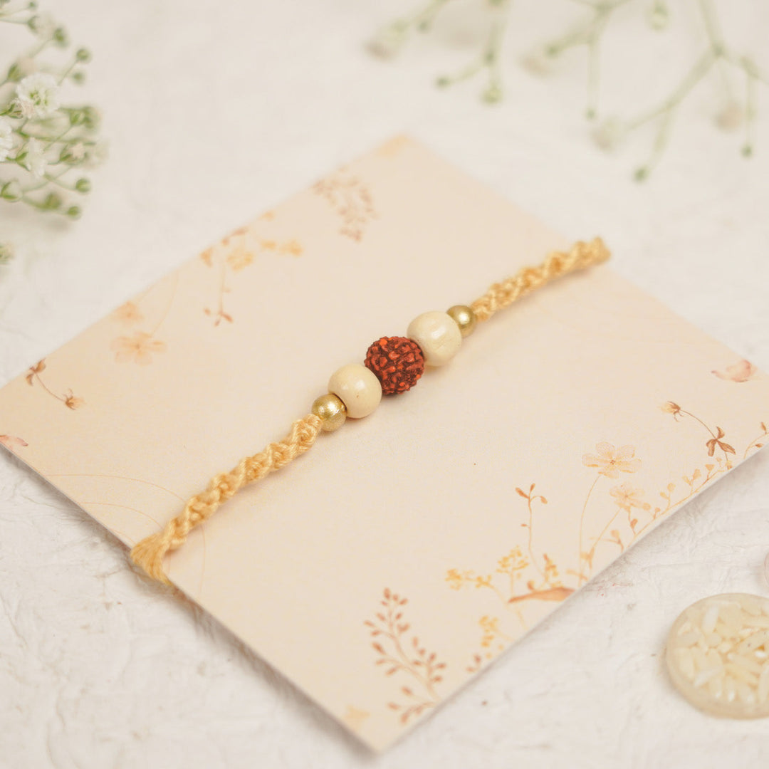 Handmade Pearl Rudraksha Rakhi With Roli Chawal - Close-up on Bracelet Design