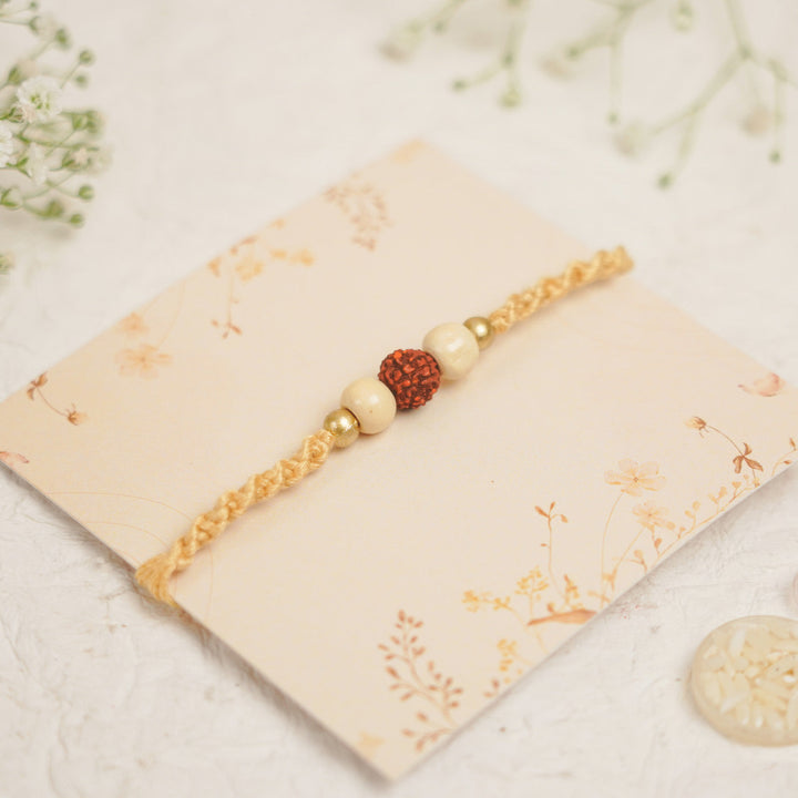 Handmade Pearl Rudraksha Rakhi With Roli Chawal - Close-up on Bracelet Design