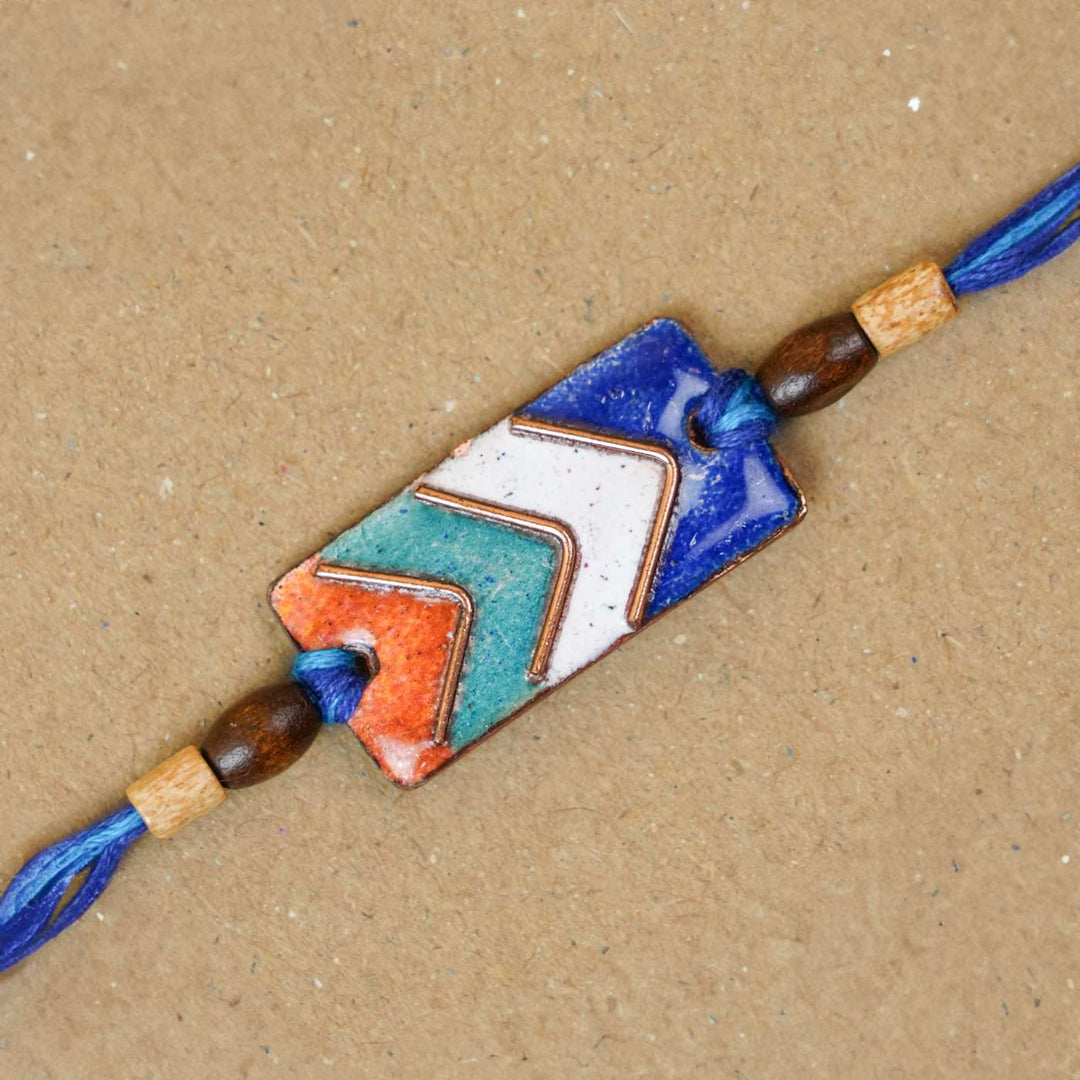 Handmade Arrows Copper Enamel Rakhi With Chocolates & Roli Chawal