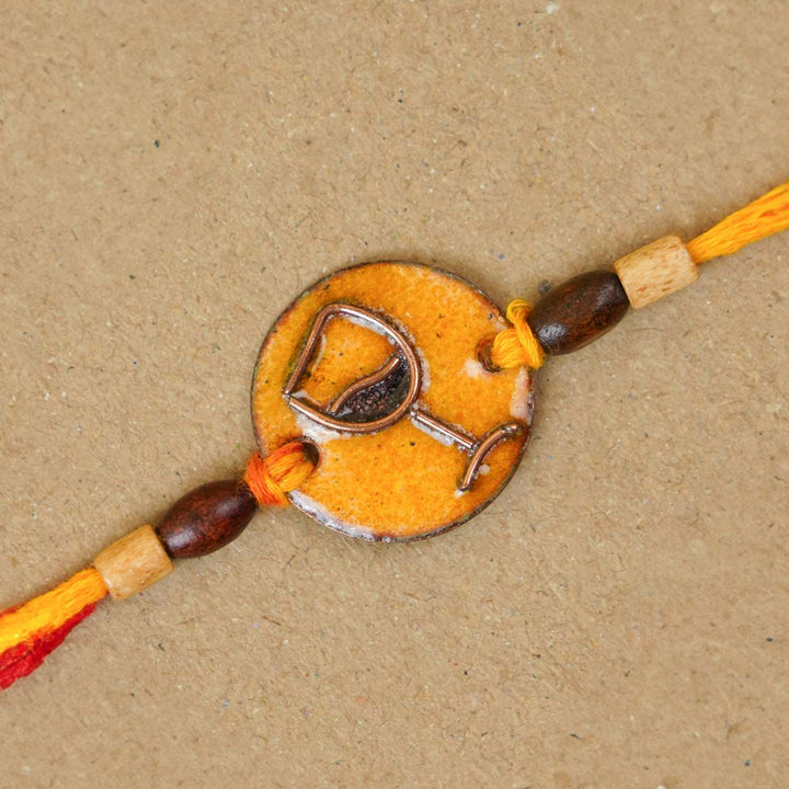 Handmade Wine O Clock Copper Enamel Rakhi With Chocolates And Roli Chawal - Close-up of bracelet centerpiece