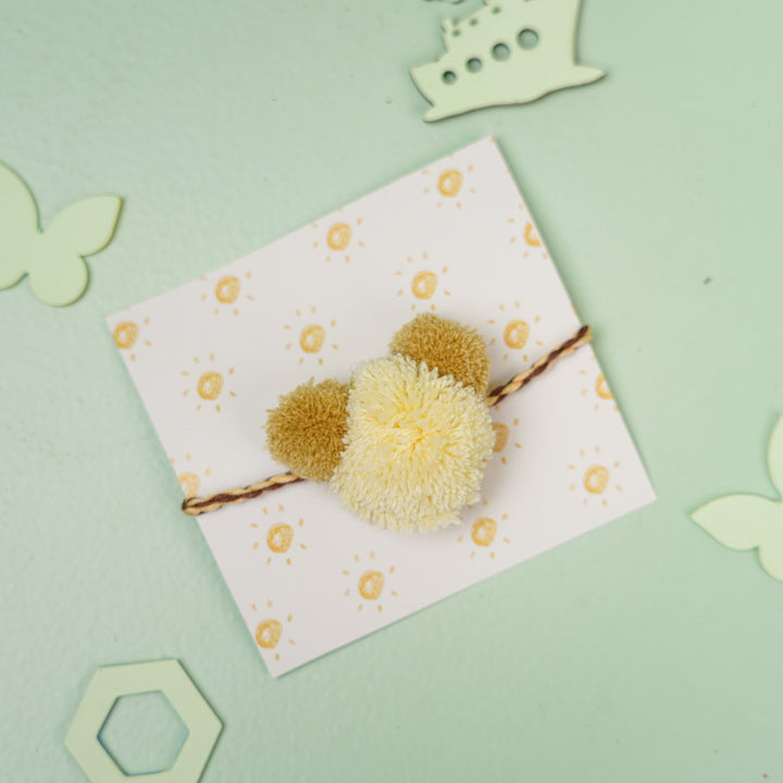 Handmade Pom Pom Teddy Design Kids Rakhi With Roli Chawal - Yellow Pom-Pom on Card