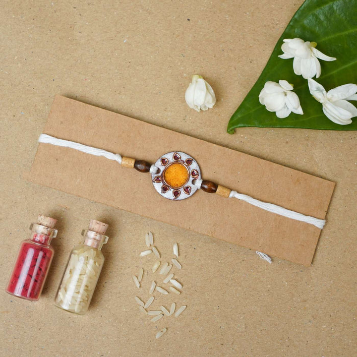 Handmade Sooraj White Copper Enamel Rakhi With Chocolates & Roli Chawal
